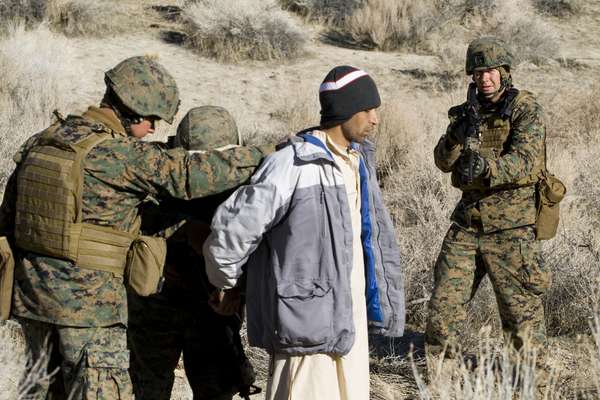 An Afghan ‘villager’ is searched by Marines and ANA role players