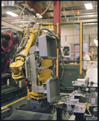 A robot moves the case along the production line