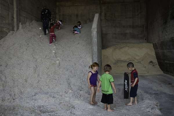 Children of the Ma’agan Michael kibbutz play on a pile of cotton