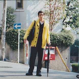 Cardigan by G-Star Raw, jumper by Black Fleece by Brooks Brothers, shirt by Brooks Brothers, trousers by Engineered Garments, shoes by Nepenthes, glasses by Four Nines, umbrella by Bottega Veneta, bag by Comme des Garçons Homme