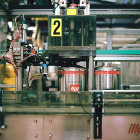 Illy’s iconic red-striped tins move along the production line