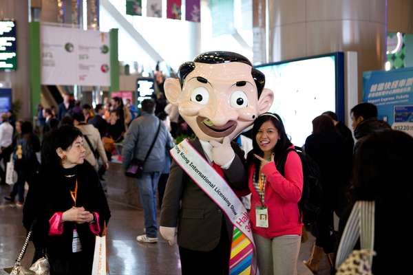 Visitor posing with fair mascot