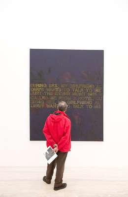 Visitor observing a Richard Prince work 