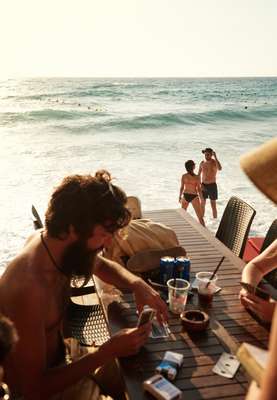 Guests play cards while others take a dip