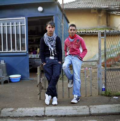 Qefser, 18, and Salmir, 17, pose in a Roma district outside of Pristina