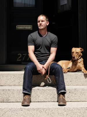 Portland citizen Brian Pramick enjoying the sun on the steps of his house