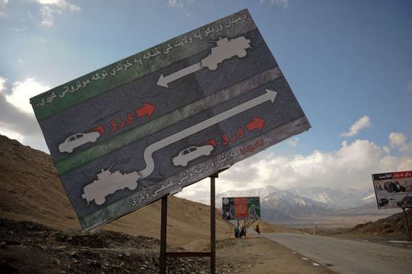 ISAF billboards warning civilians to keep back from military convoys on Highway One (the most dangerous road in Afghanistan) heading south from Maidan Shah, Wardak province