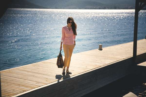 Sunglasses by Polo Ralph Lauren, t-shirt by J.Crew, trousers by Incotex, shoes by Prada, bag by Roger Vivier, watch by Omega, bracelet by Céline