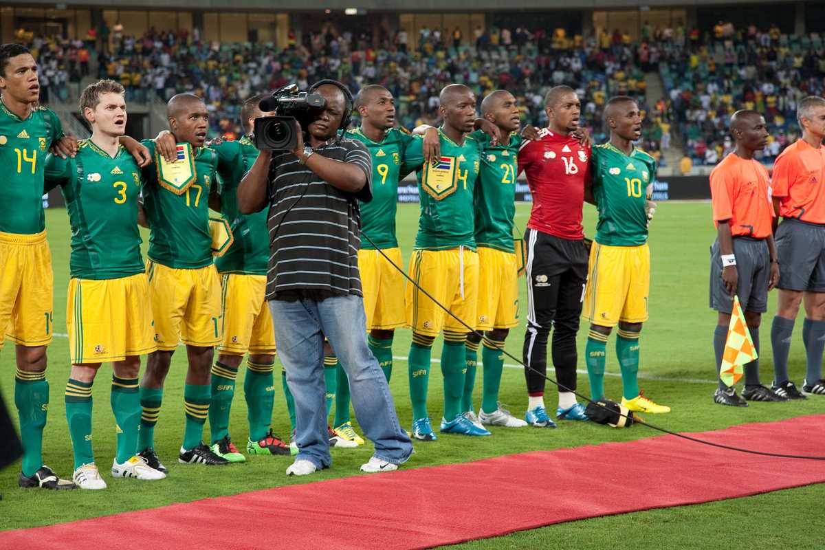 An SABC cameraman films during the South African national anthem at the Moses Mabhida stadium 