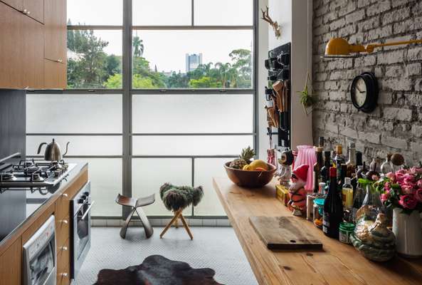 Kitchen with brick wall and hexagonal hydraulic floor tiles