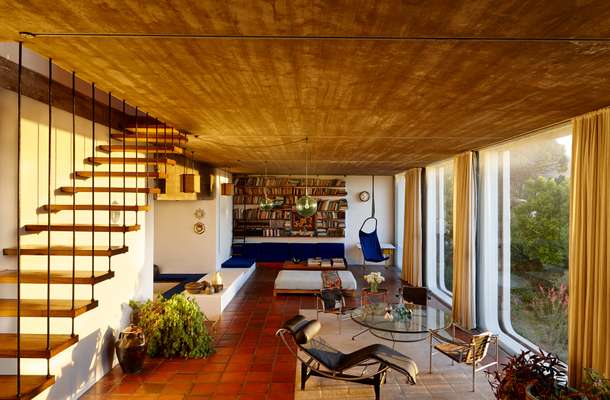 The concrete ceiling in the living room has tracks allowing light fittings and sun chairs to be easily moved