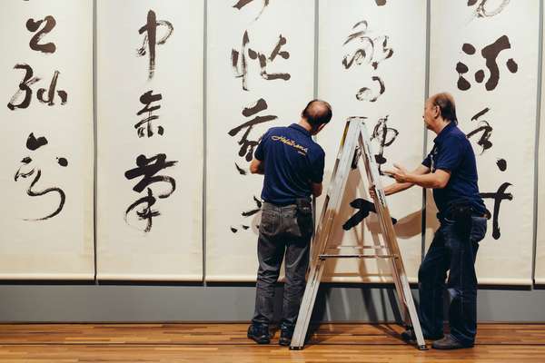 Technicians aligning the painting