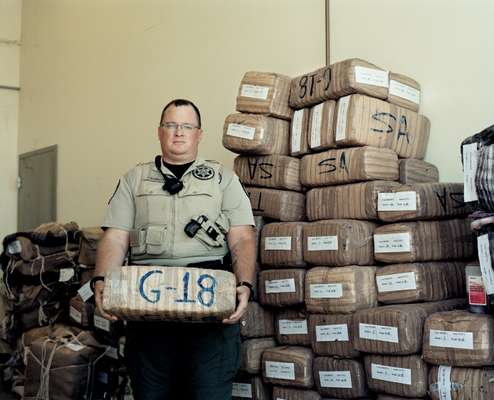 Deputy Sheriff Tim Barrett with marijuana seized from smugglers