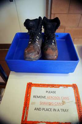 Steel-capped work boots wait to be scanned at the security check, Karratha Airport