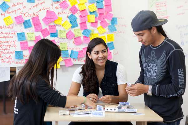 Student Stephanie Tomasetta (right), building card towers in a design class 