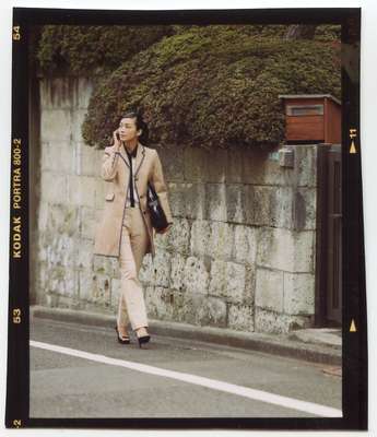 Coat by Black Fleece by Brooks Brothers, shirt by Dries Van Noten, trousers by Jil Sander, bag by Junya Watanabe Comme des Garçons, shoes by Yves Saint Laurent