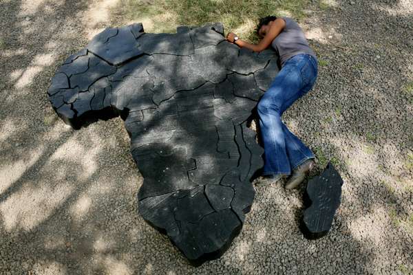 Abe by the assembled wooden jigsaw-like map