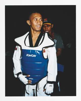 A member of the Timor Leste taekwondo team gets kitted up