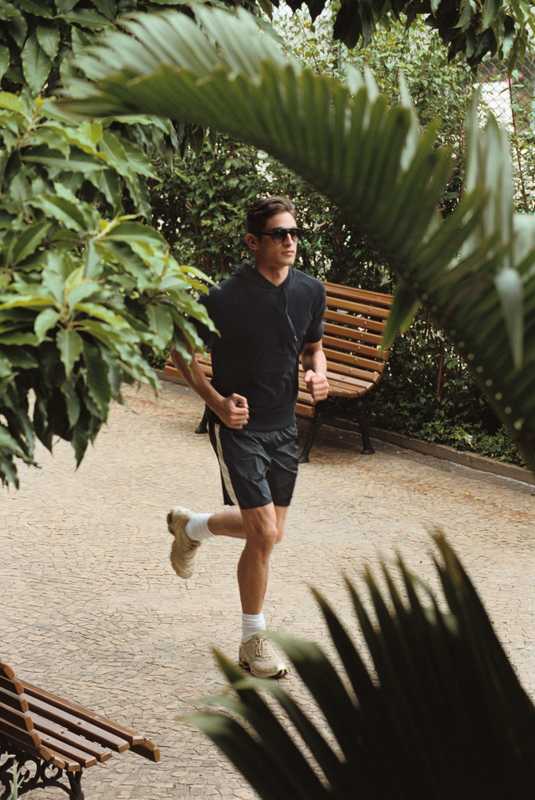 Hooded top by United Arrows, swimming trunks by Moncler, sunglasses by Thierry Lasry, socks by Hanes, shoes by Mizuno