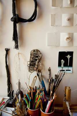 Paint brushes and pencils in studio