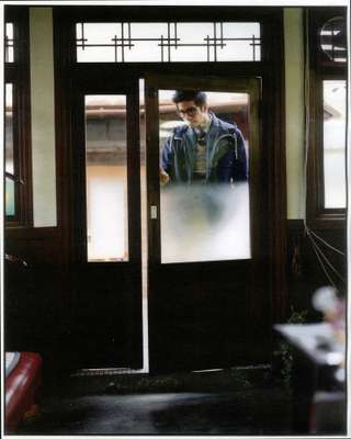 Glasses by Moscot, coat by Comme des Garçons Junya Watanabe Man, jacket by Emiliano Rinaldi for Tomorrowland, tank top, shirt and tie by Polo Ralph Lauren