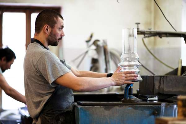 A worker in the polishing workshop checks that a piece is level