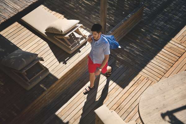 Shirt by Moustache, shorts by Post O’alls, bag by Bill Amberg, sandals by Salvatore Ferragamo, watch by Omega