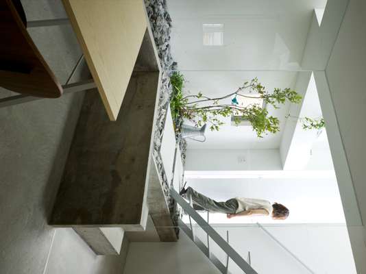 Entrance with plain white walls, glass and skylights 