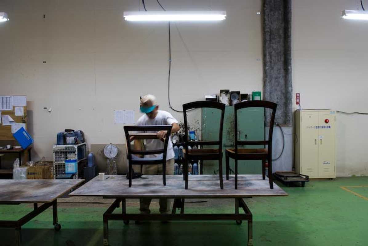 A worker checking the quality of chairs