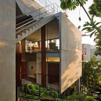 Living room with large windows on both sides, looking out to beach and jungle respectively