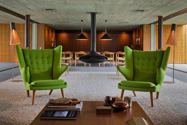 Hans Wegner-designed AP-19s, otherwise known as 'Teddy Bear Chairs', with a suspended fireplace behind them