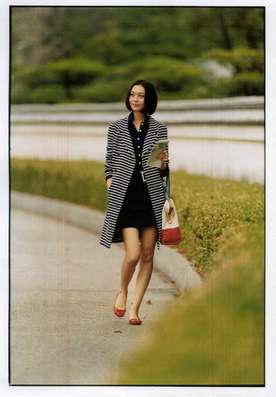 Coat by Christian Dior, dress, bag and shoes by Fendi, earrings and bracelet by Duna