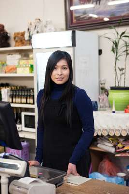 Vu Thi Jen working in the Asian Food Market at Dong Xuan Center 