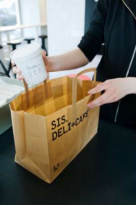 Paper bags carry the chequered motif 