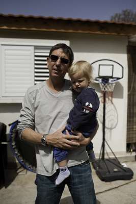 Boaz Alon and his son outside their house in Mishmar Hasharon 