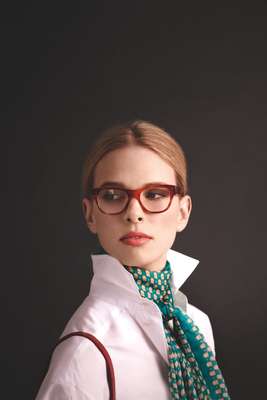 Glasses by Oliver Peoples, scarf and bag by Delvaux, shirt by Trussardi