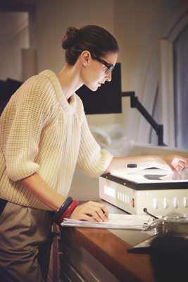 Glasses by Claire Goldsmith, jumper and bracelets by Hermès, trousers by 1205, pen by Cartier