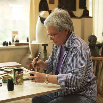 Artist Ludmila Bogatova puts the final touches to a souvenir in her studio on the outskirts of the city