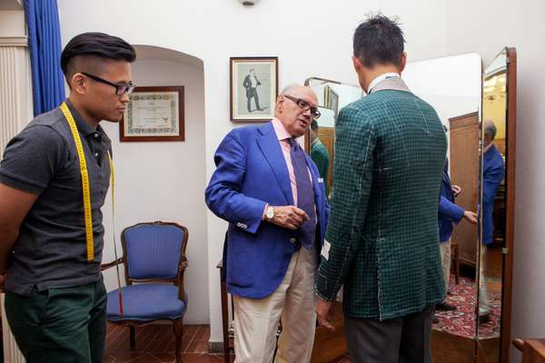 Choi observing at a suit fitting