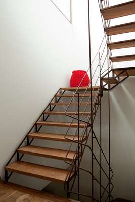 Industrial-style stairwell is flooded with sunshine from a skylight 