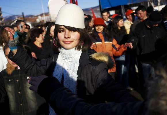 A Kosovo Albanian, wearing the traditional Albanian hat, celebrates in Mitrovica