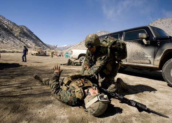 A Marine treats a ‘fallen’ comrade