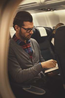 Glasses by Persol, cardigan by Zanone, shirt by Blue Work from Tomorrowland, jeans by J.Crew