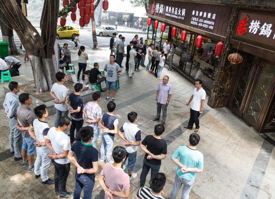 Restaurant employees line up before dinner service begins