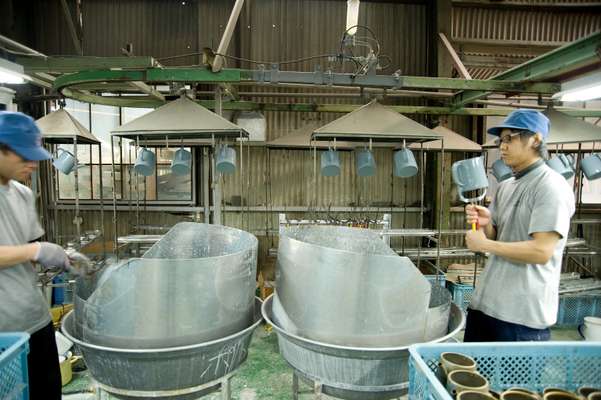 Steel pots in the first stage of enamelling