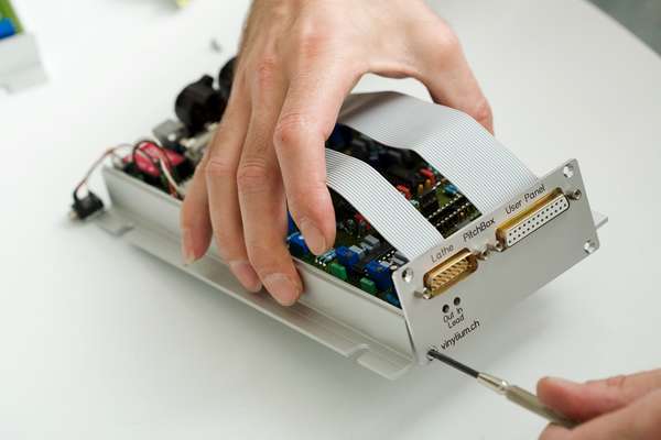 Screwing together the components of a cutting lathe computer