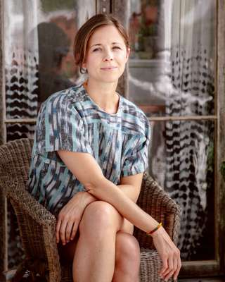 Harper Poe of Proud Mary Textiles on the piazza of her Charleston home