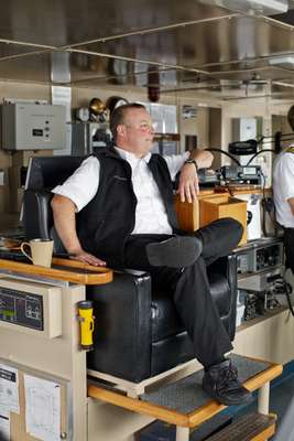 Captain Ken Grieser sits watch in the captain’s chair
