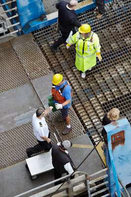 Crew work shoreside to secure the car ramp