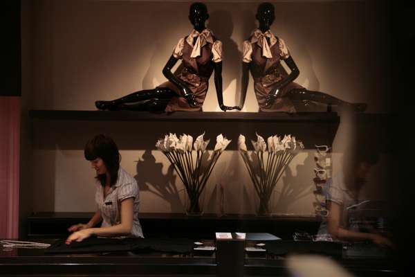 A boutique-shop worker sets up a display in the People’s Company shopping mall